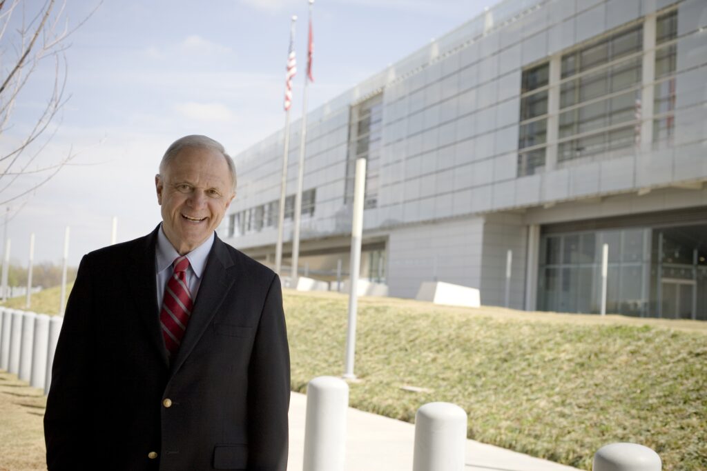 Sen. David Pryor stands in front of the Clinton Presidential Library and Museum.